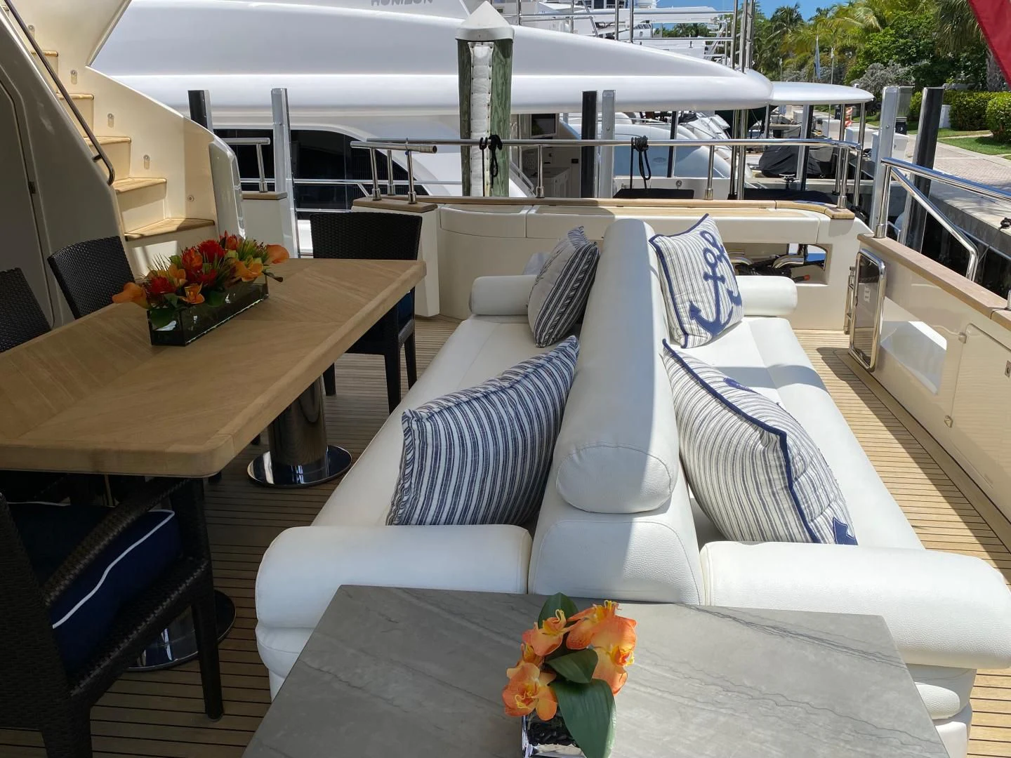 a boat with white and blue striped pillows on it aboard ADAR Yacht for Sale