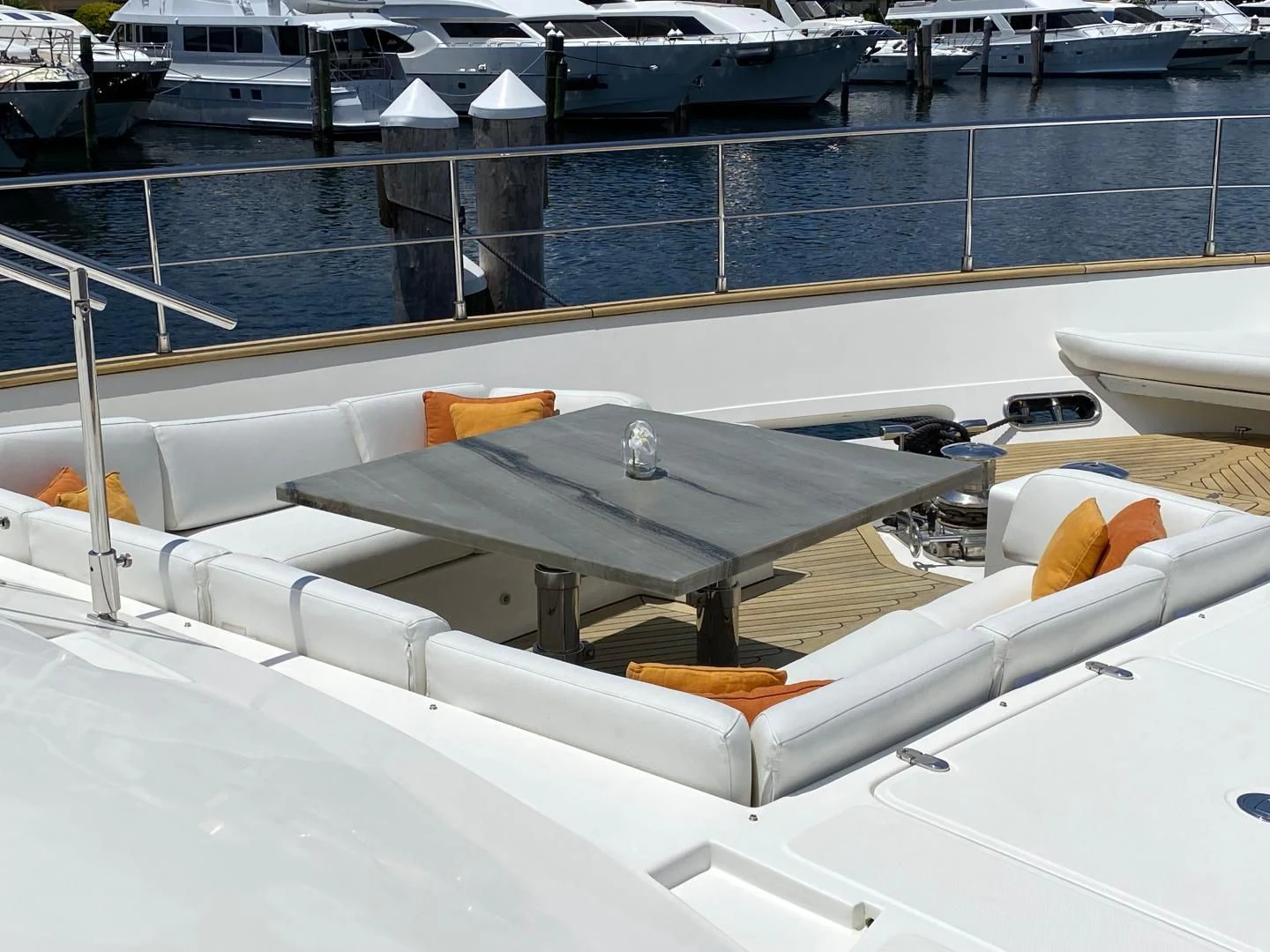 a deck with a table and chairs aboard ADAR Yacht for Sale