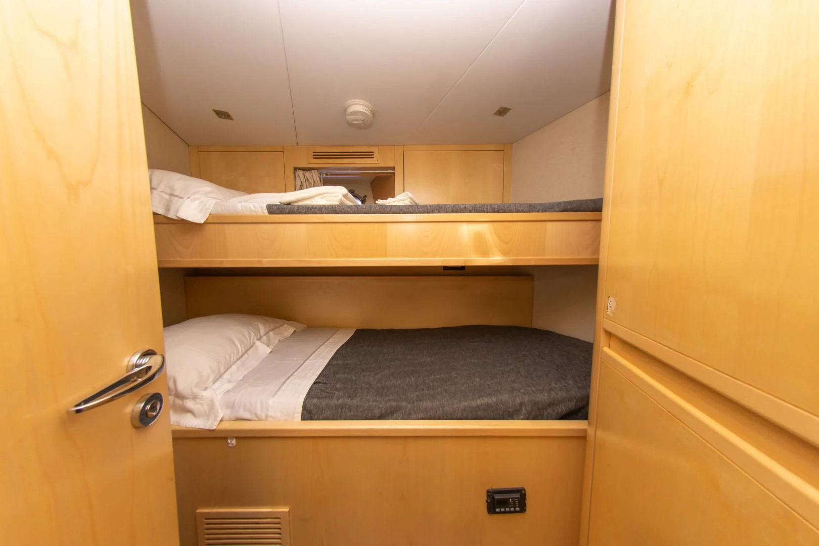 a room with bunk beds aboard ADAR Yacht for Sale