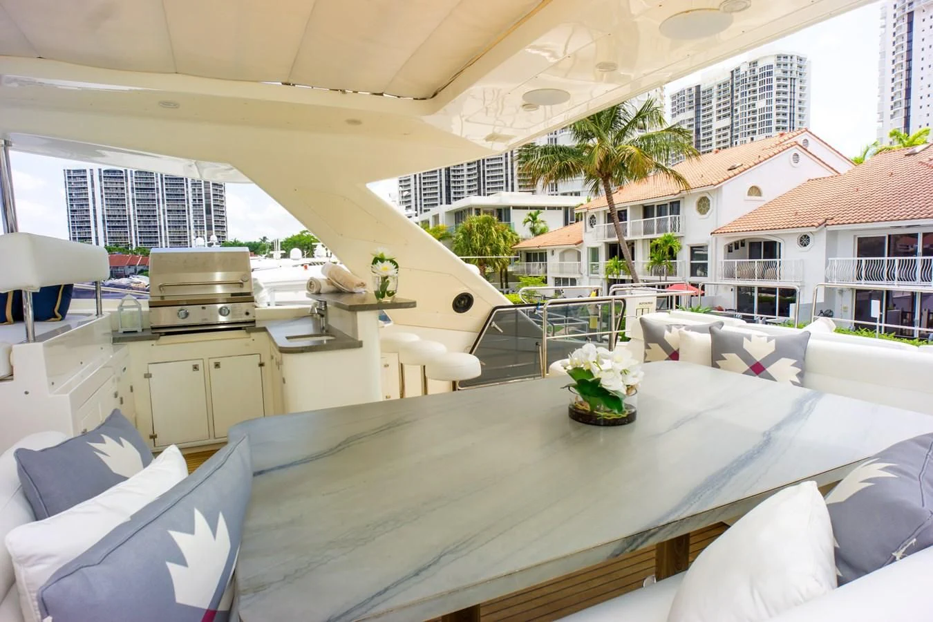 a large white room with a table and chairs and a plant on the table aboard ADAR Yacht for Sale