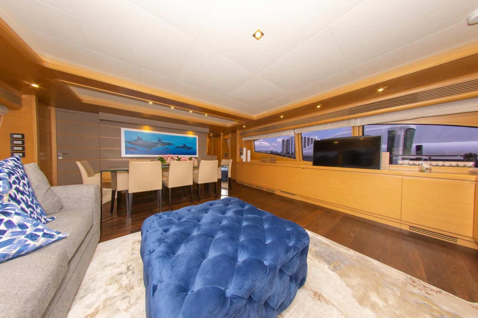 a living room with a large television aboard ADAR Yacht for Sale