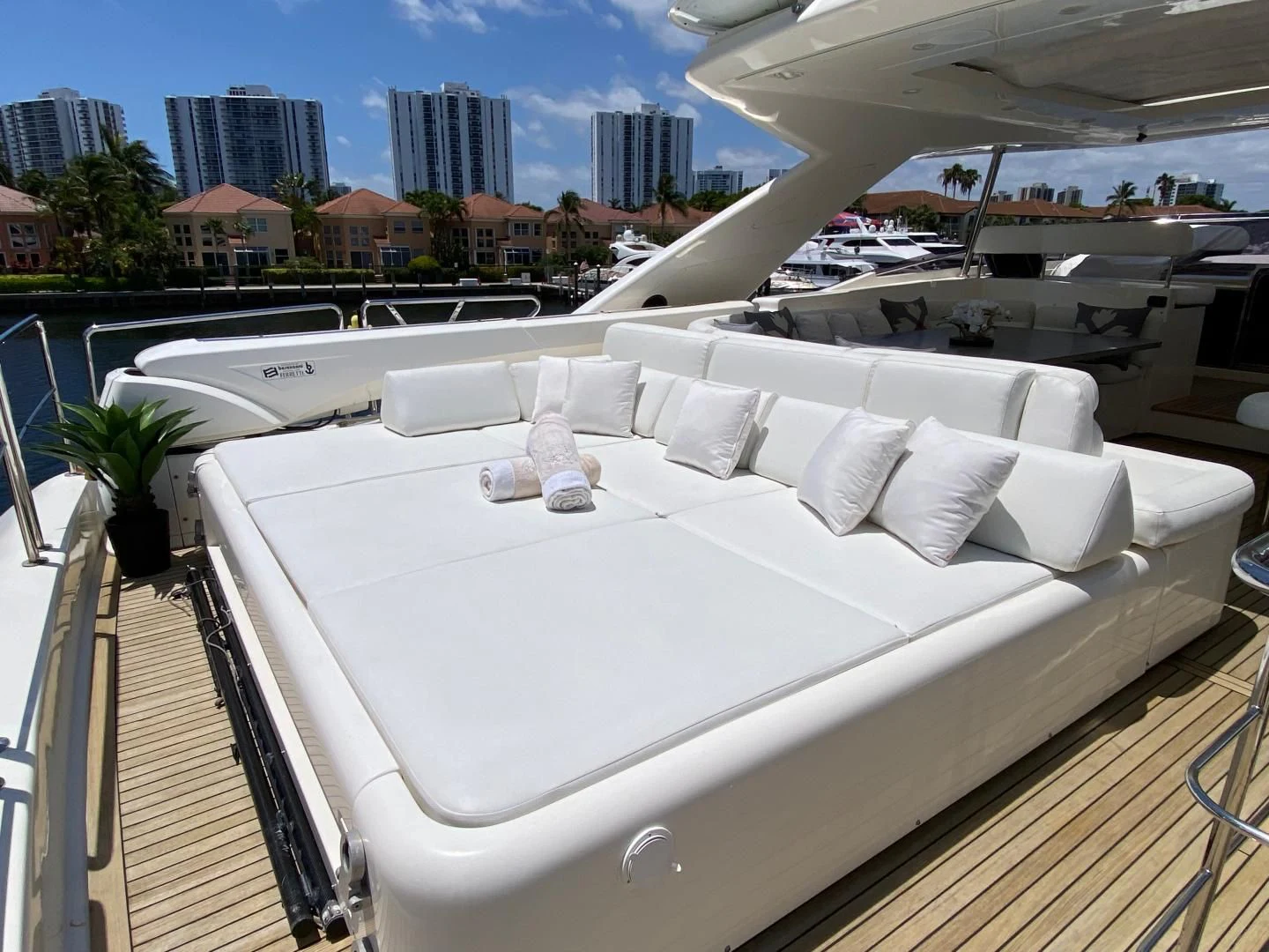 a large white bed on a balcony aboard ADAR Yacht for Sale