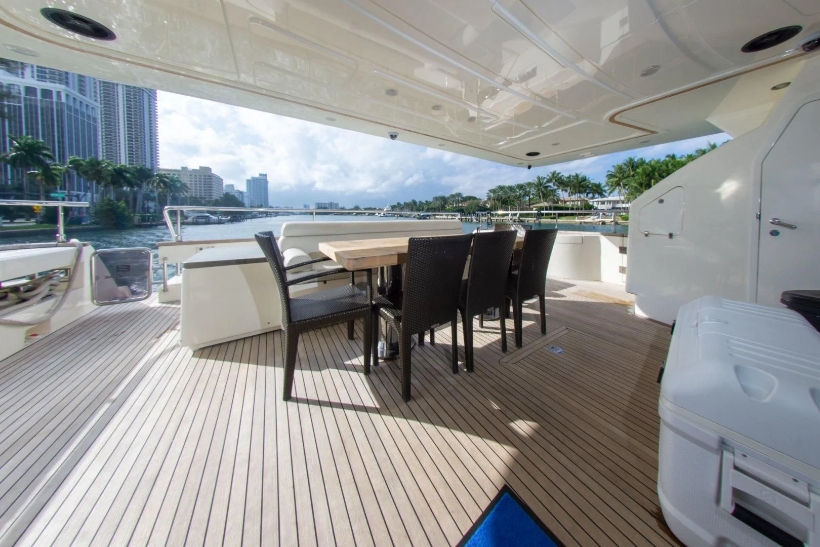 a deck with a table and chairs aboard ADAR Yacht for Sale