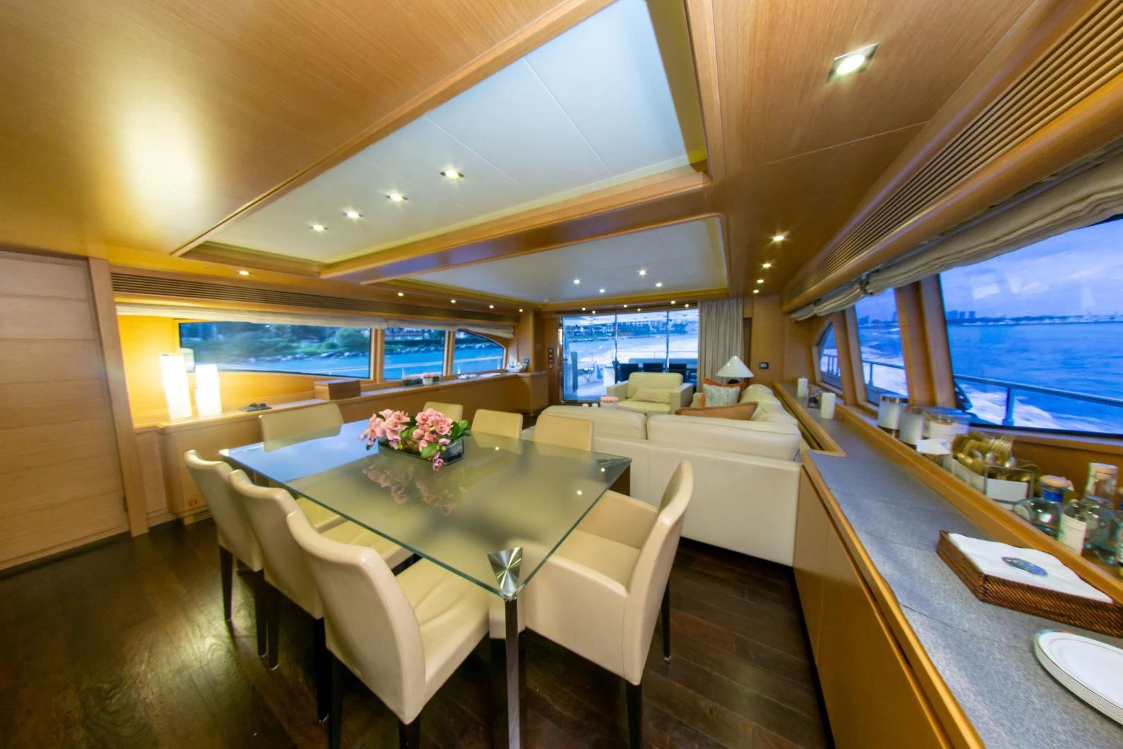 a large room with a table and chairs aboard ADAR Yacht for Sale