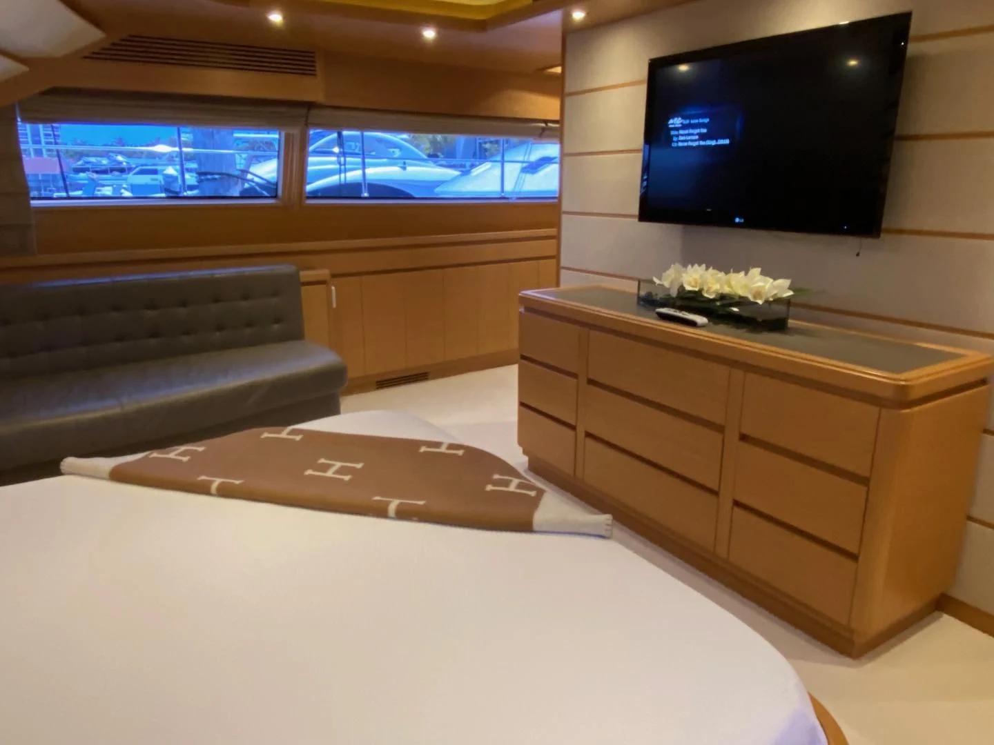 a room with a bed and tv aboard ADAR Yacht for Sale