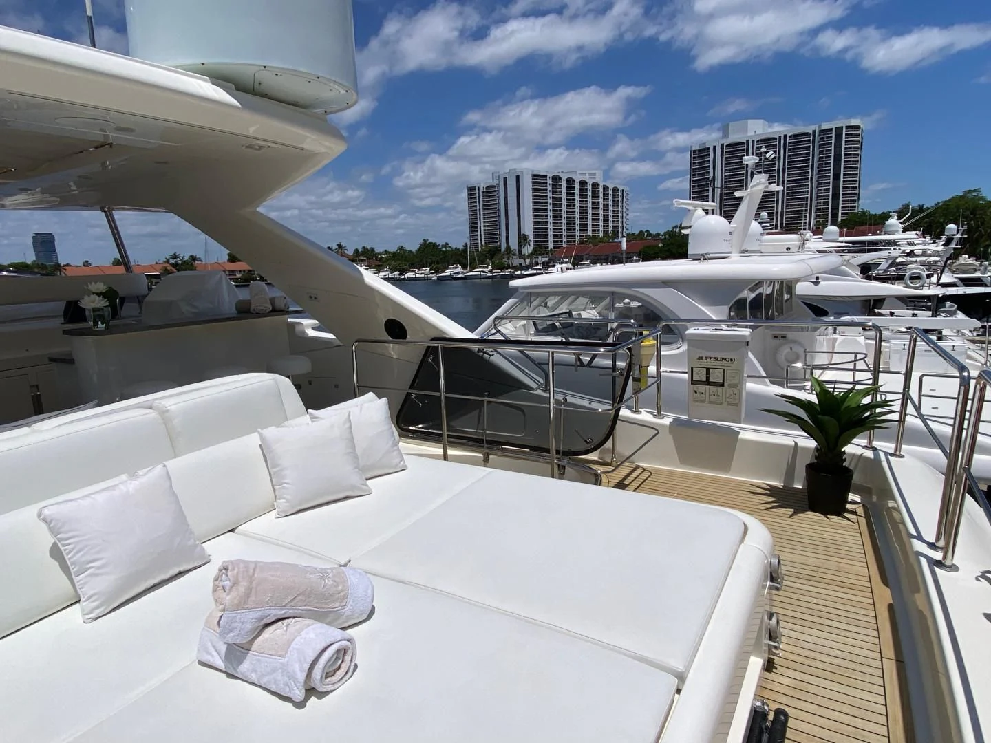 a large white bed on a balcony aboard ADAR Yacht for Sale