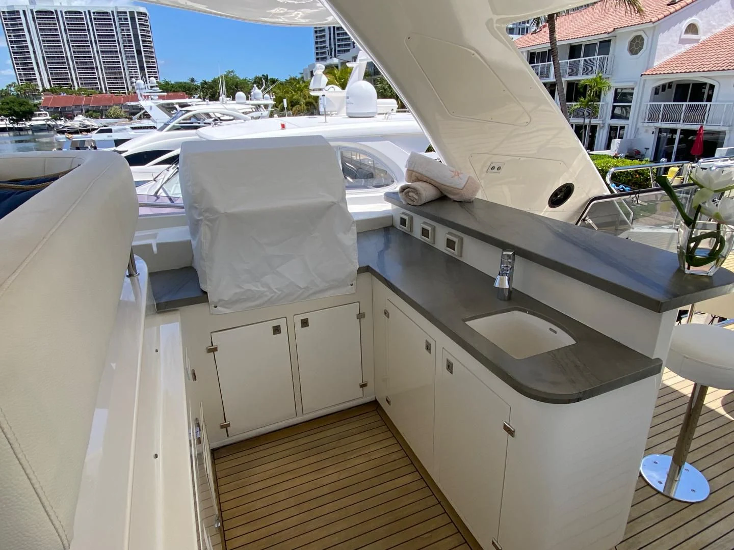 a white boat in a harbor aboard ADAR Yacht for Sale