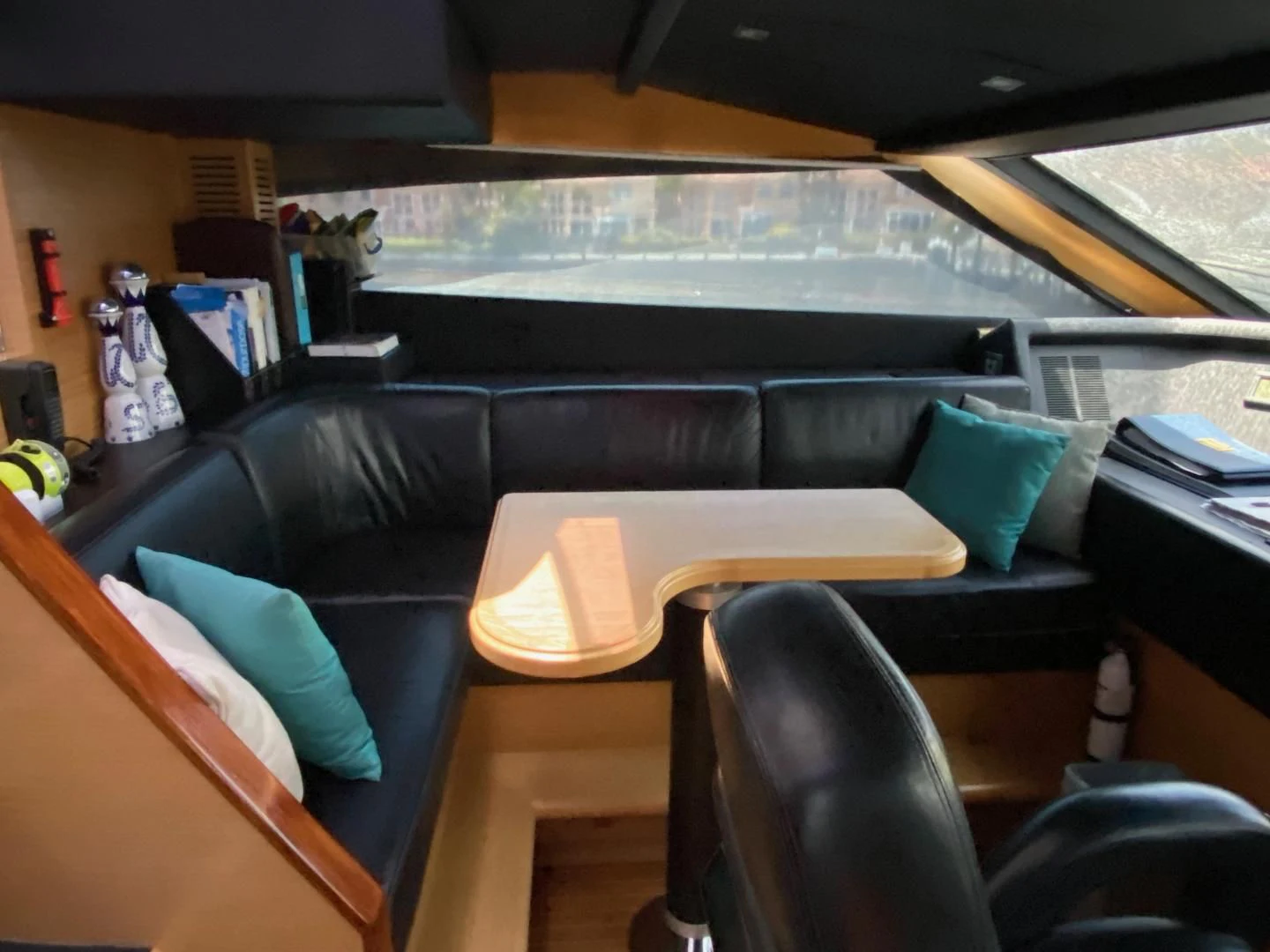 inside of a vehicle with a desk and chairs and a window with a view of the city and aboard ADAR Yacht for Sale