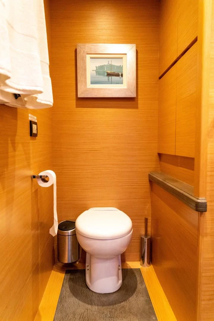 a toilet with a seat up aboard ADAR Yacht for Sale