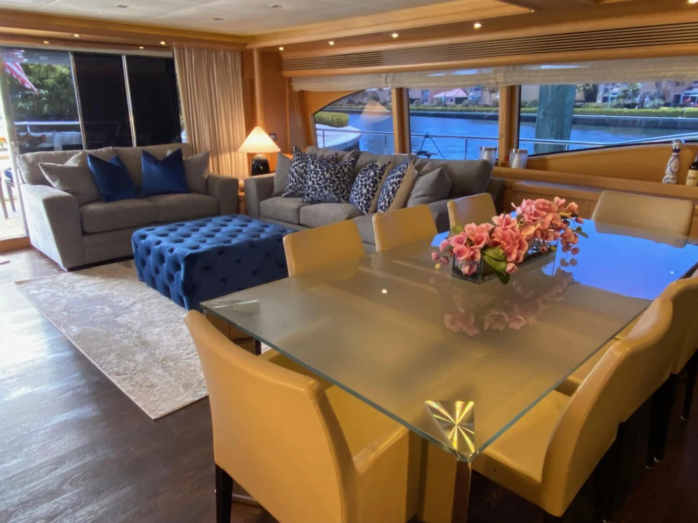 a living room with a table and couches aboard ADAR Yacht for Sale