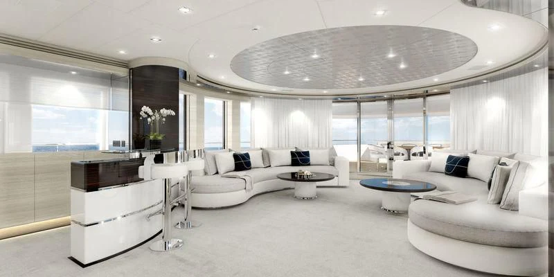 a large white living room with a large white sofa and a large window aboard MASA Yacht for Sale
