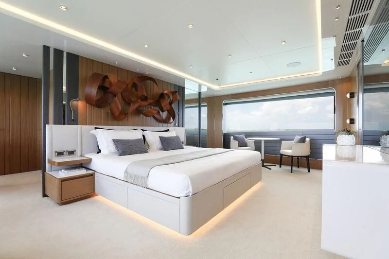 a modern bedroom with a large bed aboard A SALT WEAPON Yacht for Charter
