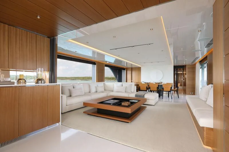 a modern living room with a large window aboard A SALT WEAPON Yacht for Charter