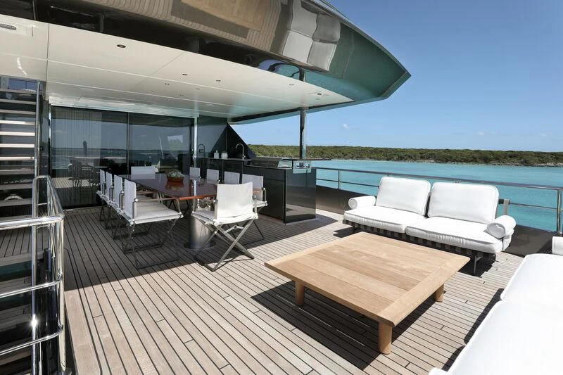 a deck with a couch and a table on it aboard A SALT WEAPON Yacht for Charter