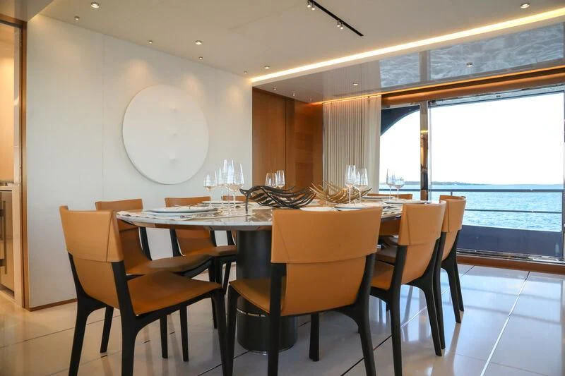 a table with wine glasses on it aboard A SALT WEAPON Yacht for Charter