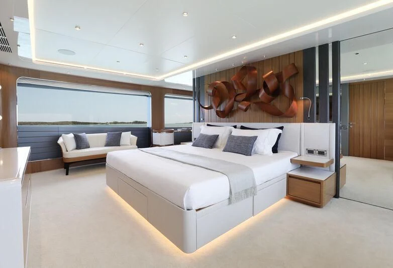 a room with a bed and a couch aboard A SALT WEAPON Yacht for Charter