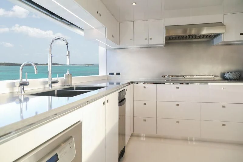 a kitchen with white cabinets aboard A SALT WEAPON Yacht for Charter