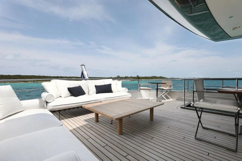 a deck with a pool and lounge chairs on it aboard A SALT WEAPON Yacht for Charter