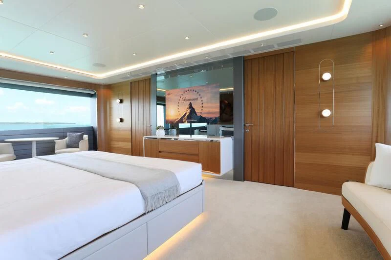 a room with a bed and a desk aboard A SALT WEAPON Yacht for Charter