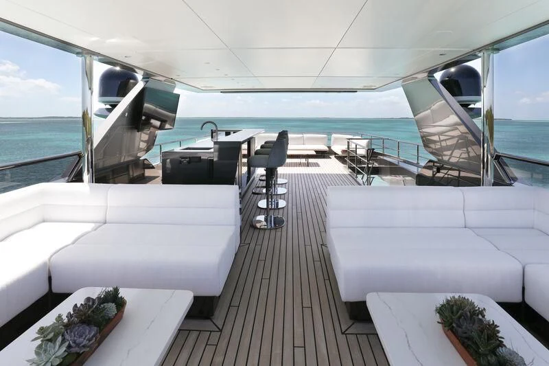 a boat with a table and chairs aboard A SALT WEAPON Yacht for Charter