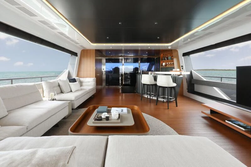 a living room with a large window aboard A SALT WEAPON Yacht for Charter