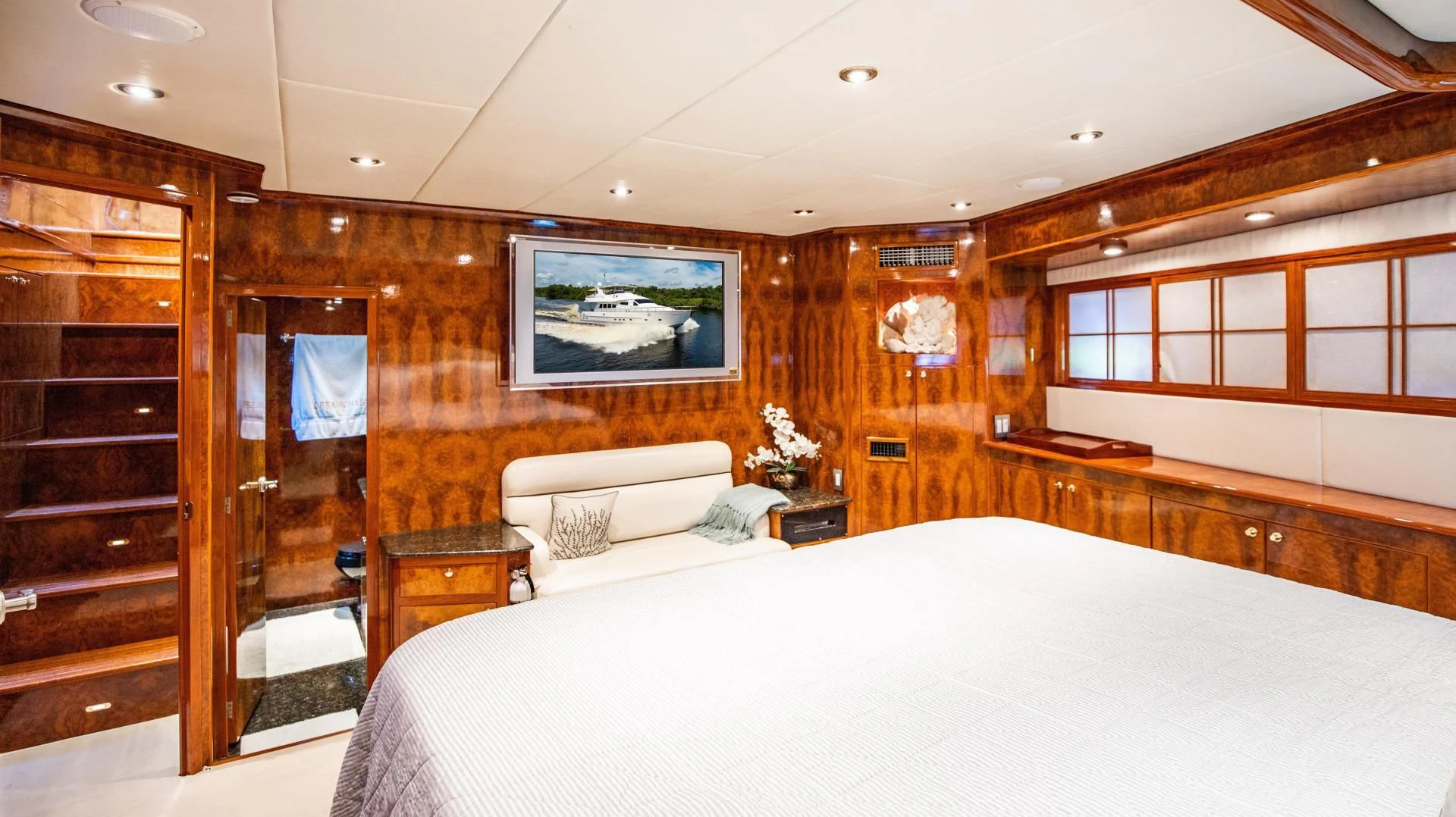 a room with a bed and a wood door aboard DREAMCHASER Yacht for Sale