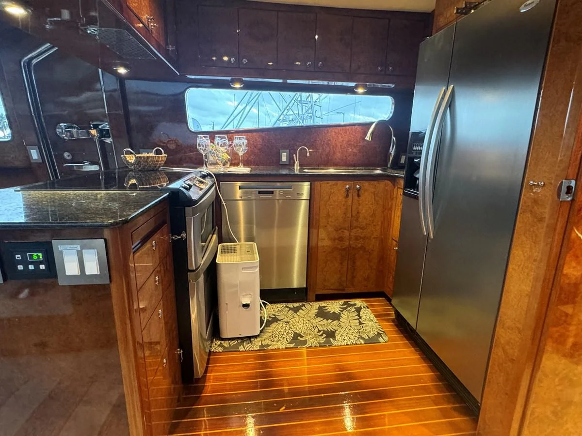 a kitchen with a stainless steel refrigerator aboard DREAMCHASER Yacht for Sale