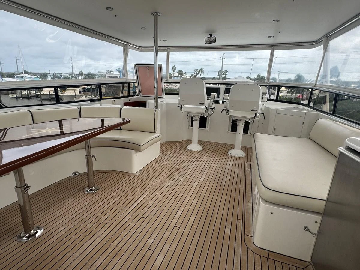 a boat with a table and chairs aboard DREAMCHASER Yacht for Sale
