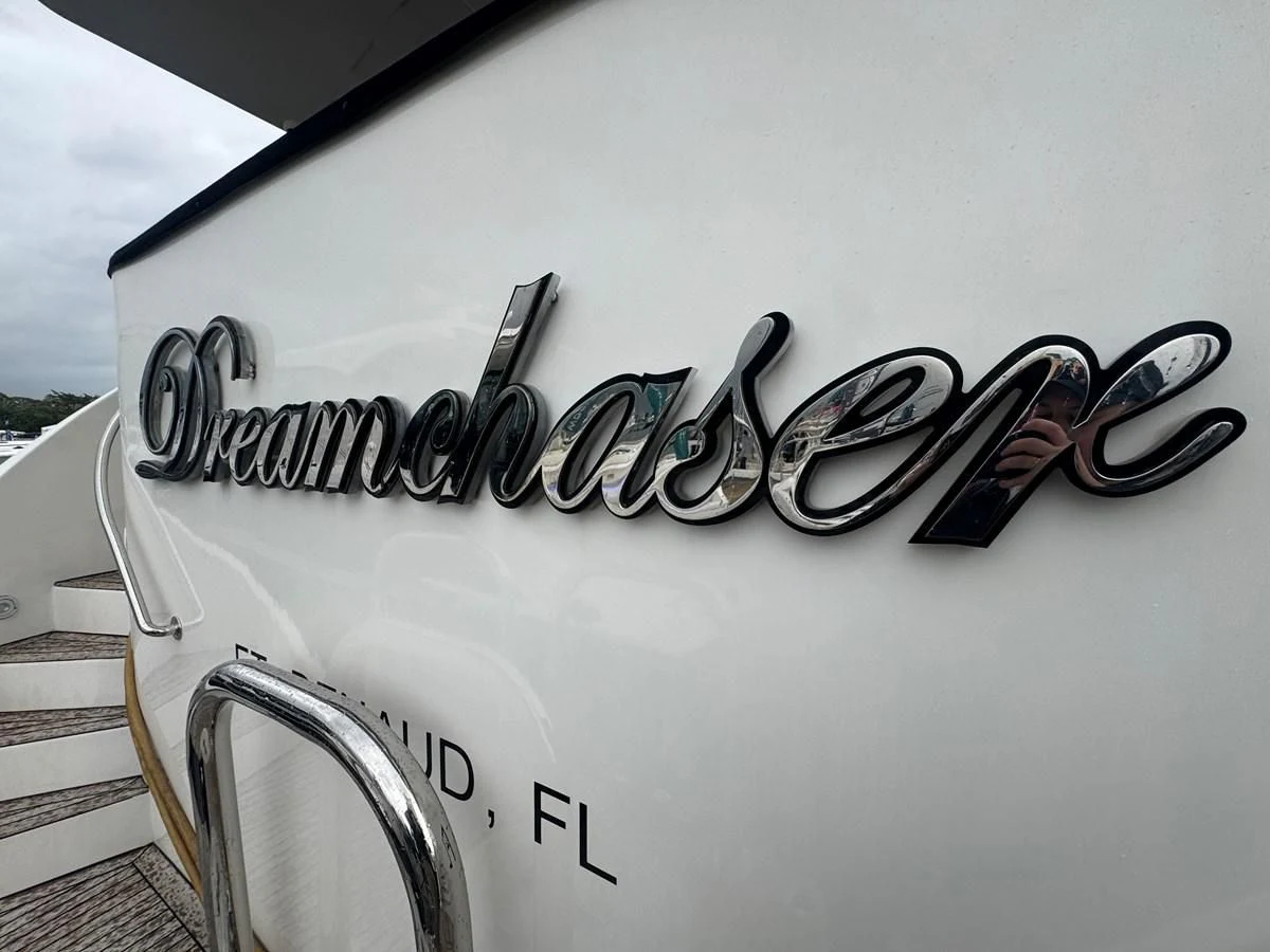 a white car with black text on it aboard DREAMCHASER Yacht for Sale