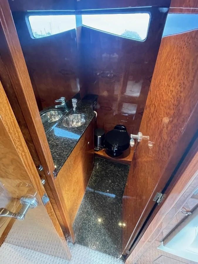 a bathroom with a sink and a mirror aboard DREAMCHASER Yacht for Sale
