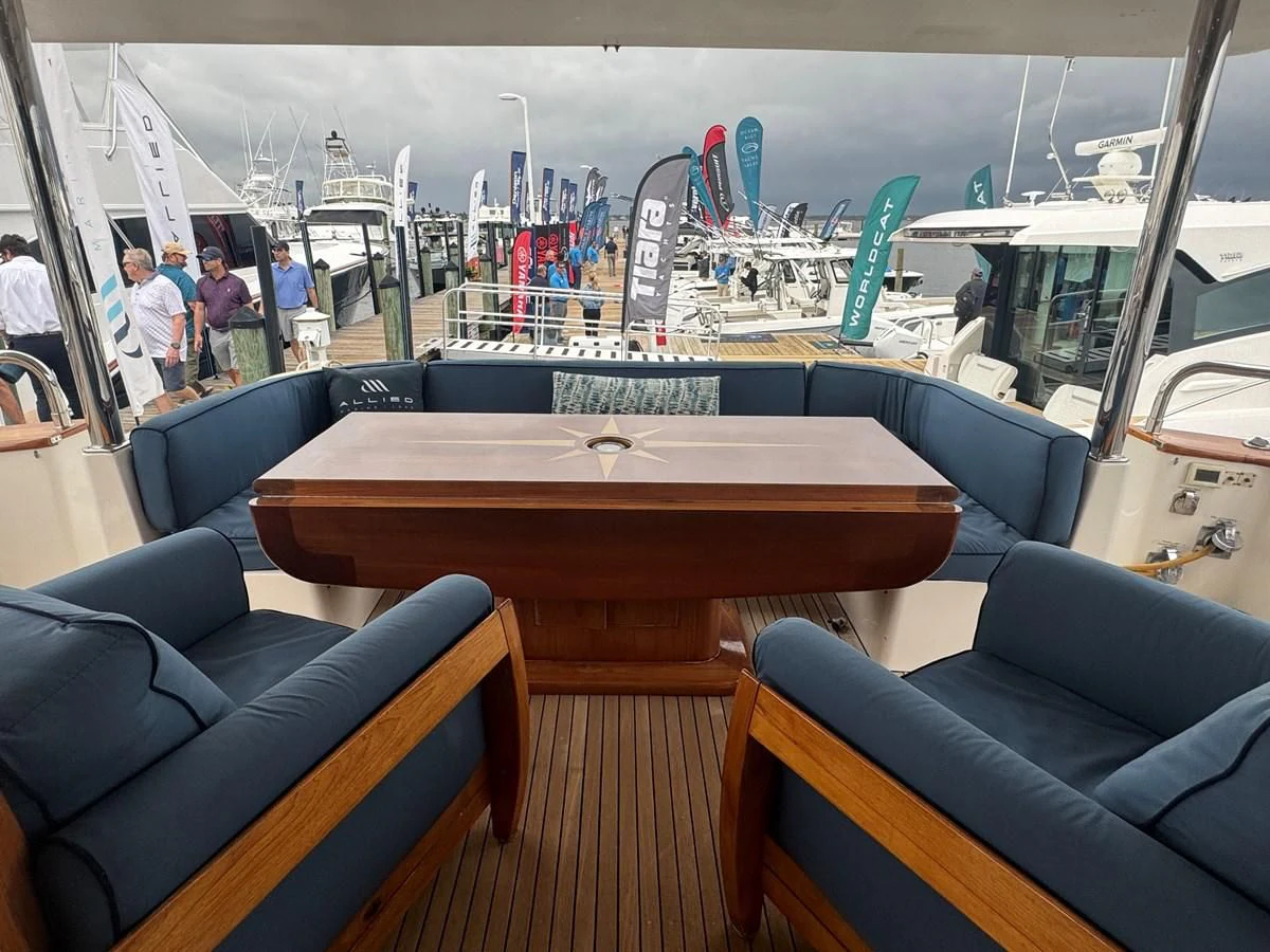 a table with chairs and a bench aboard DREAMCHASER Yacht for Sale