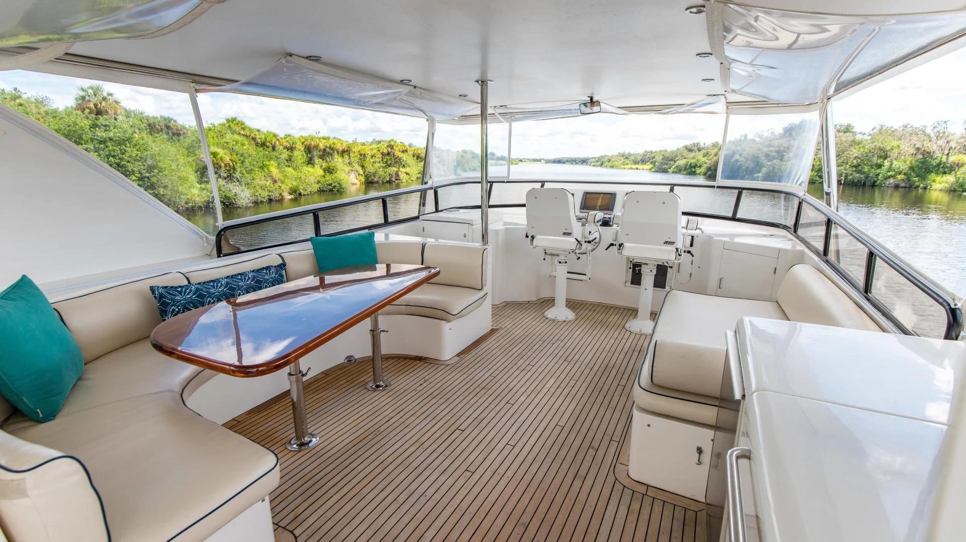 a boat with a deck and chairs aboard DREAMCHASER Yacht for Sale