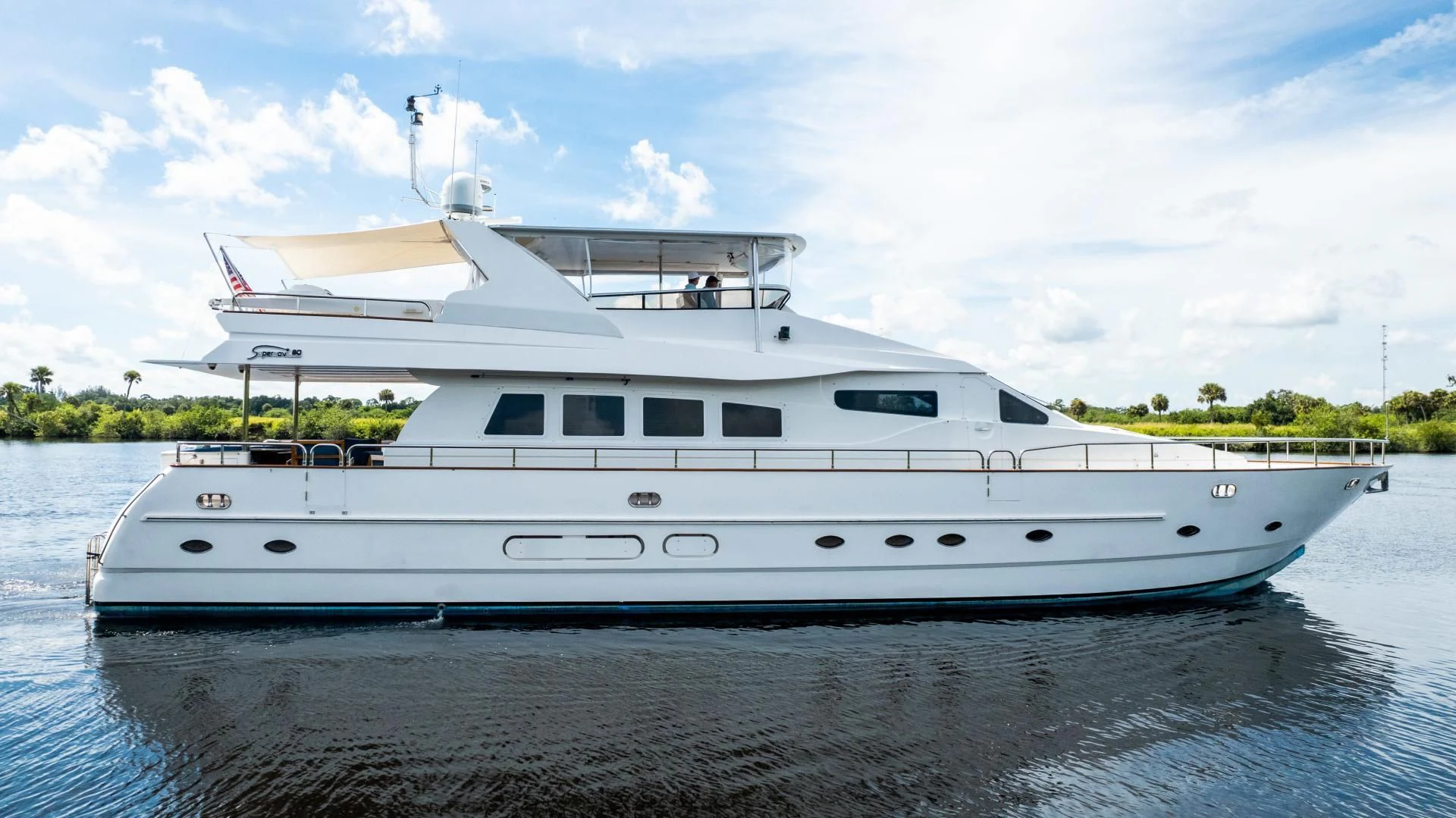 a white yacht on the water aboard DREAMCHASER Yacht for Sale