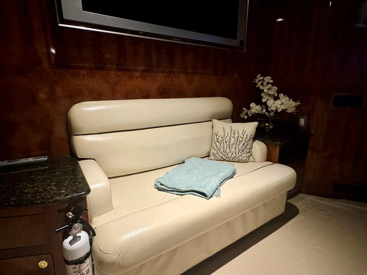 a white couch in a room aboard DREAMCHASER Yacht for Sale