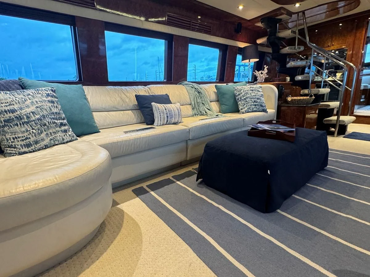 a living room with a couch and a tv aboard DREAMCHASER Yacht for Sale