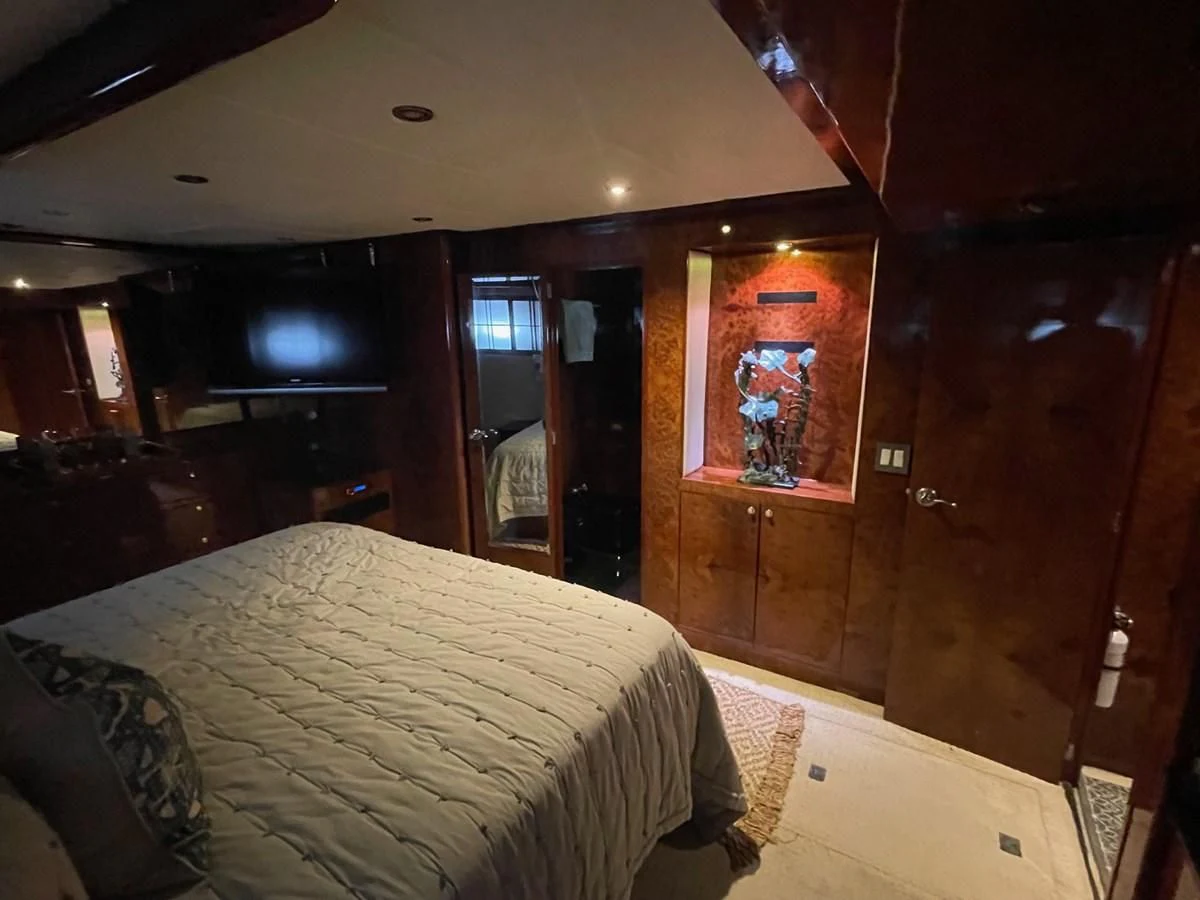 a bedroom with a bed aboard DREAMCHASER Yacht for Sale