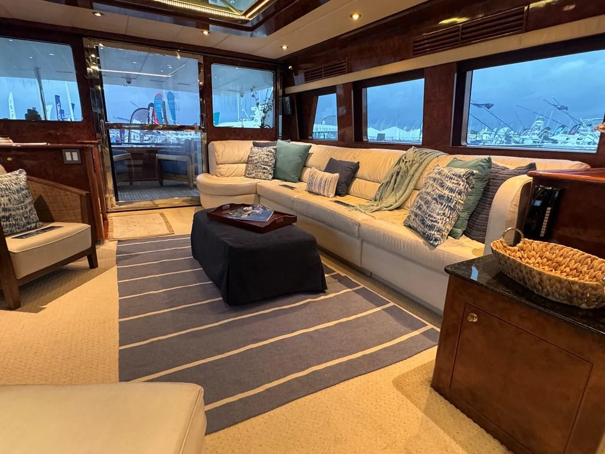 a living room with a couch and a tv aboard DREAMCHASER Yacht for Sale