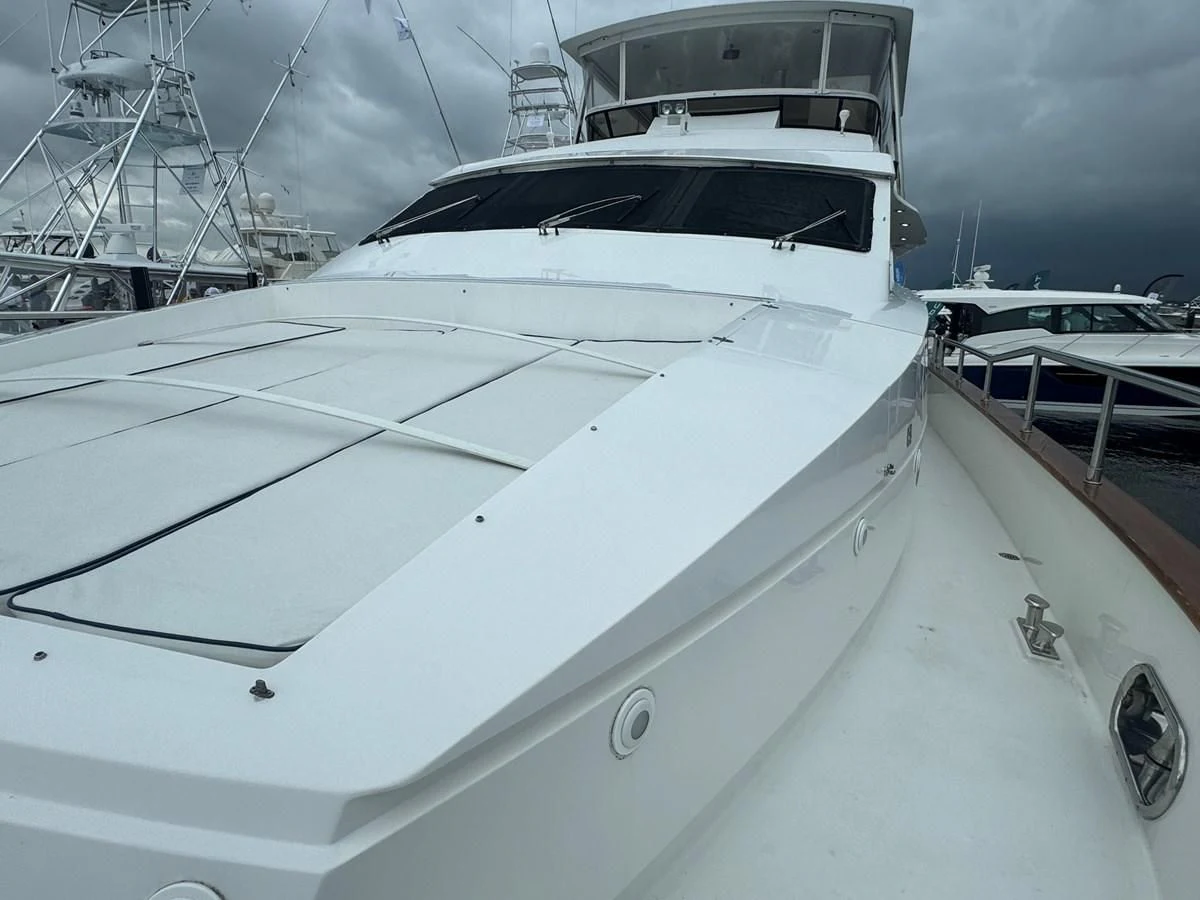 a white yacht on a dock aboard DREAMCHASER Yacht for Sale