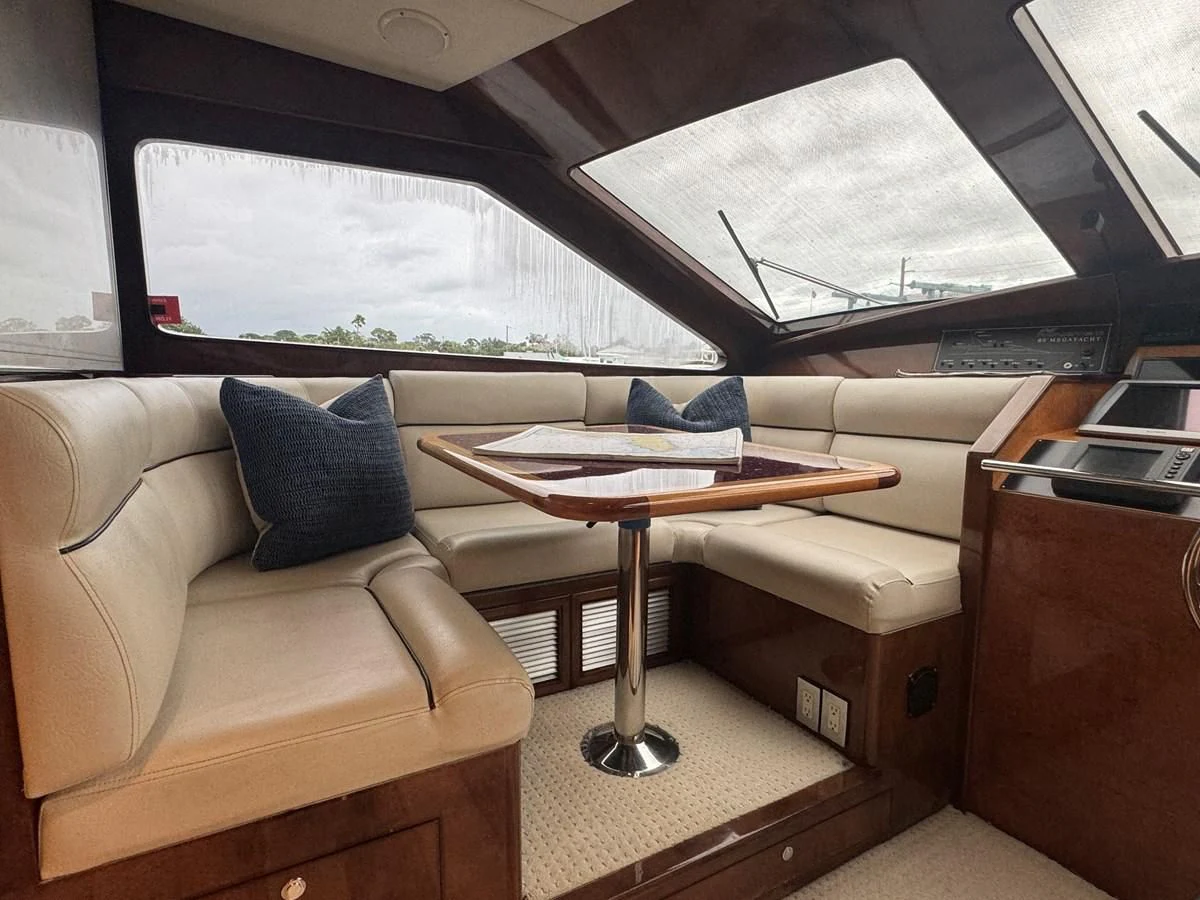 a room with a couch and a table aboard DREAMCHASER Yacht for Sale