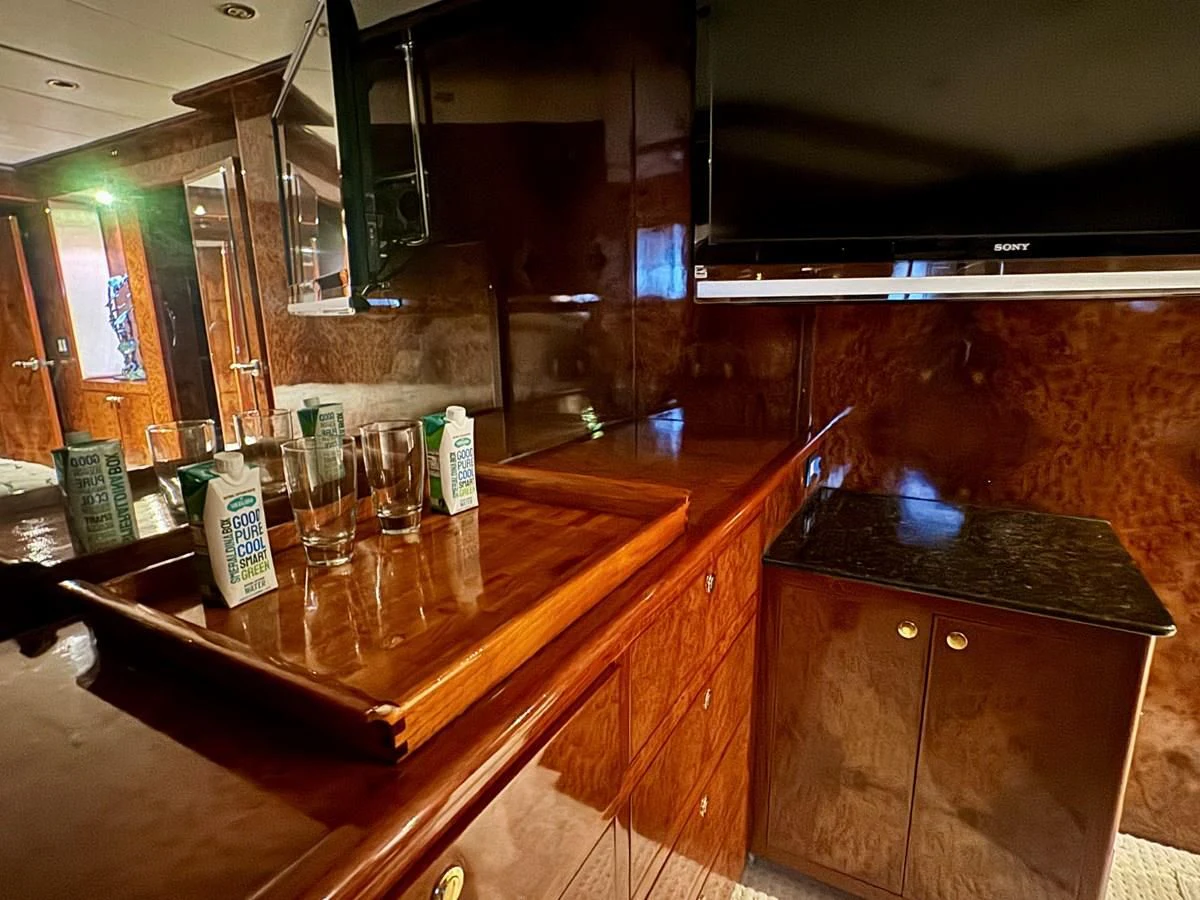 a bar with a counter and glasses aboard DREAMCHASER Yacht for Sale