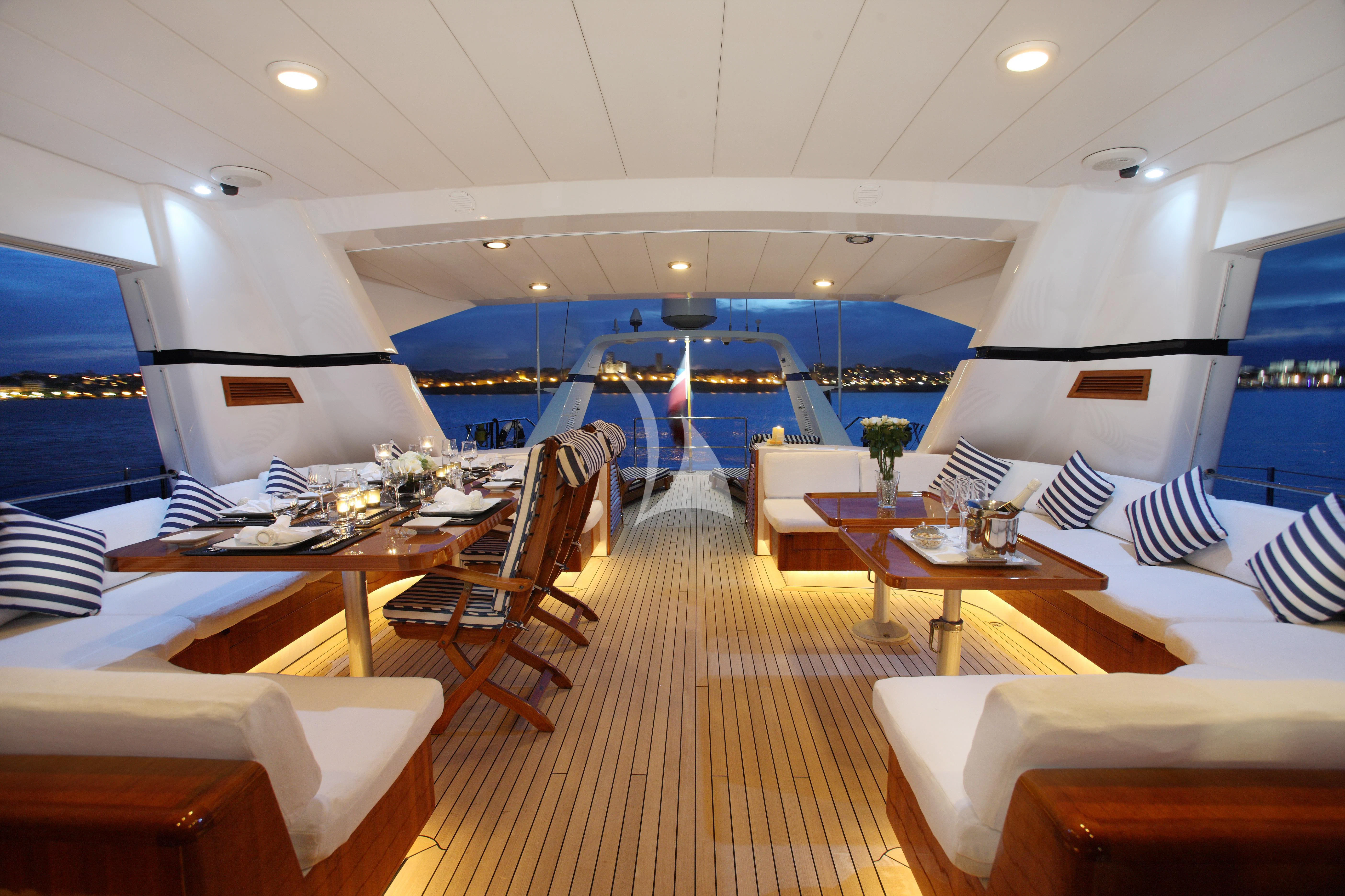 a room with tables and chairs aboard UNPLUGGED Yacht for Sale
