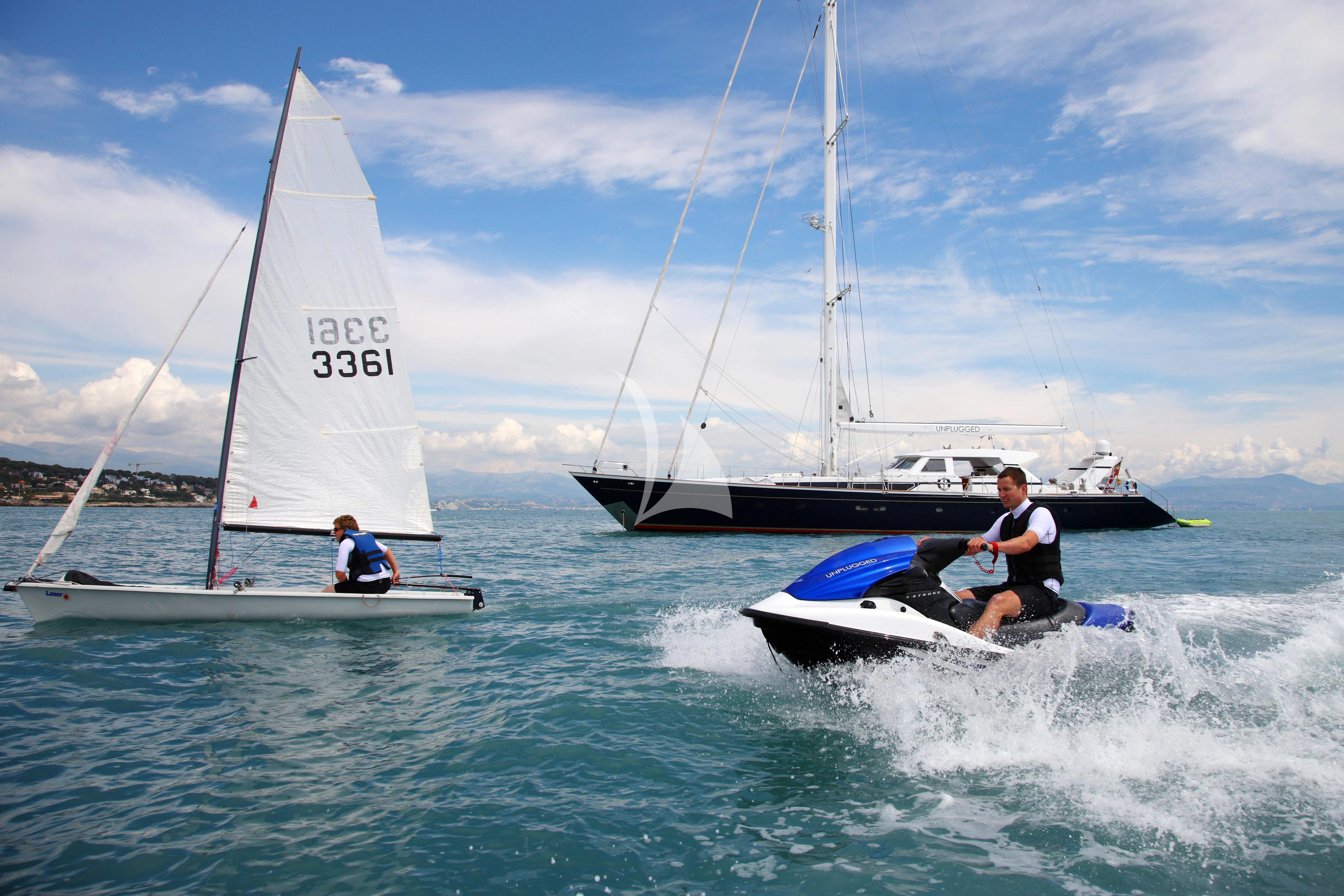 a couple of people on a sailboat in the water aboard UNPLUGGED Yacht for Sale