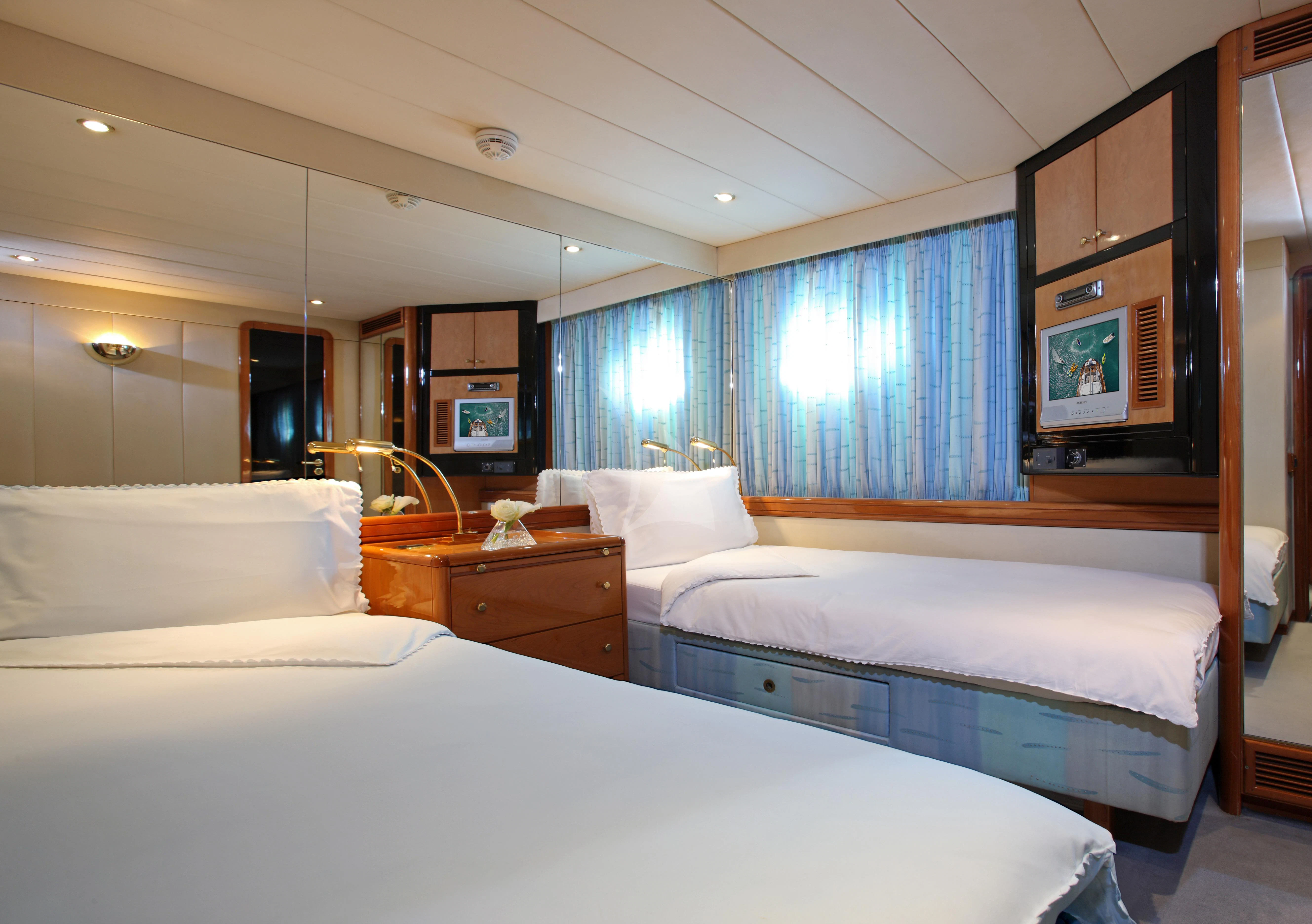 a room with two beds aboard UNPLUGGED Yacht for Sale