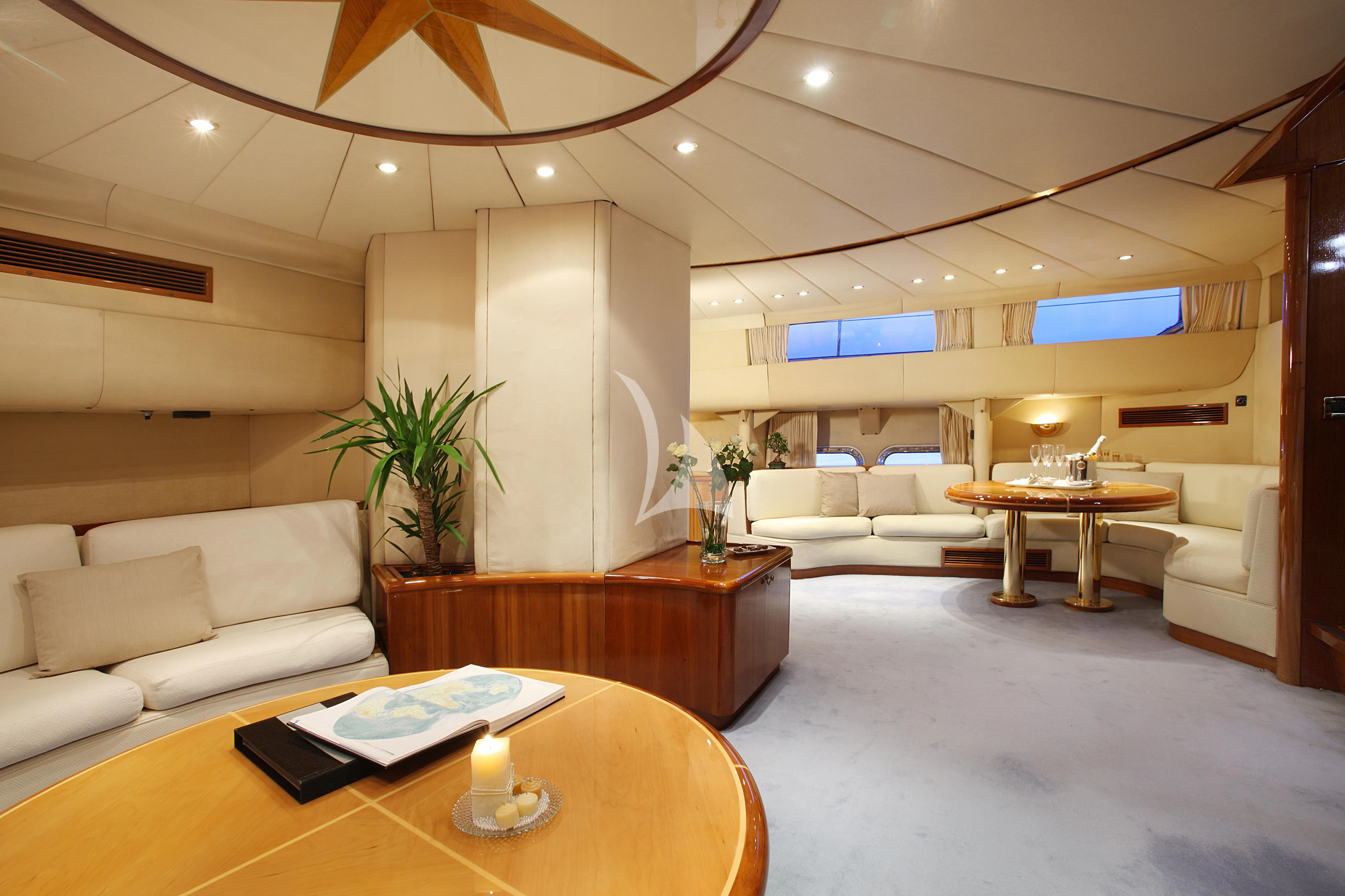 a living room with a table and couches aboard UNPLUGGED Yacht for Sale