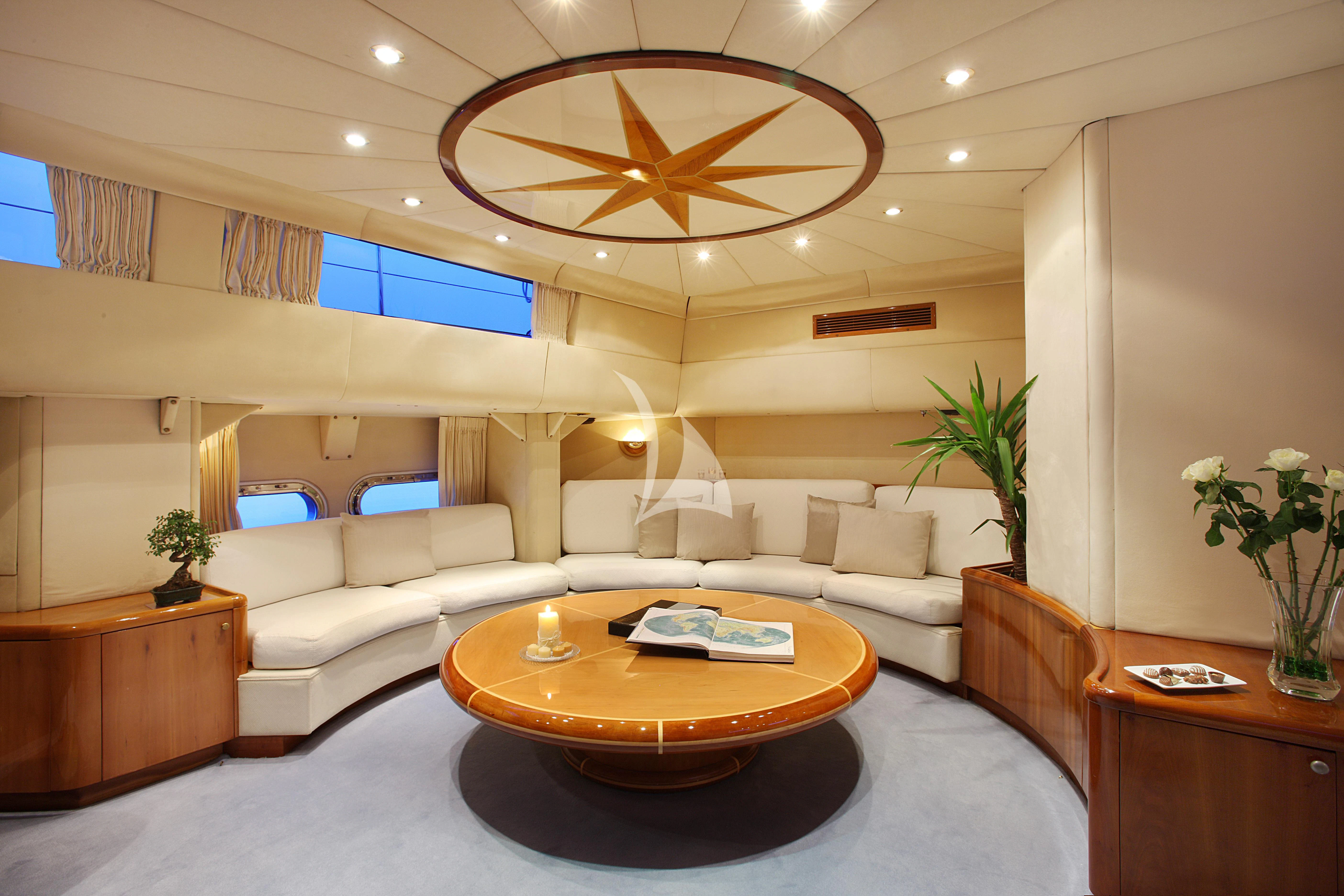 a living room with a large chandelier aboard UNPLUGGED Yacht for Sale