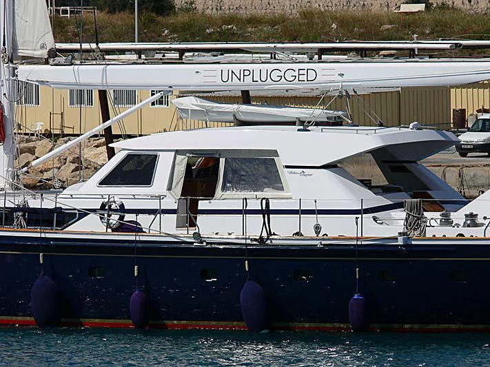 a boat parked in a harbor aboard UNPLUGGED Yacht for Sale