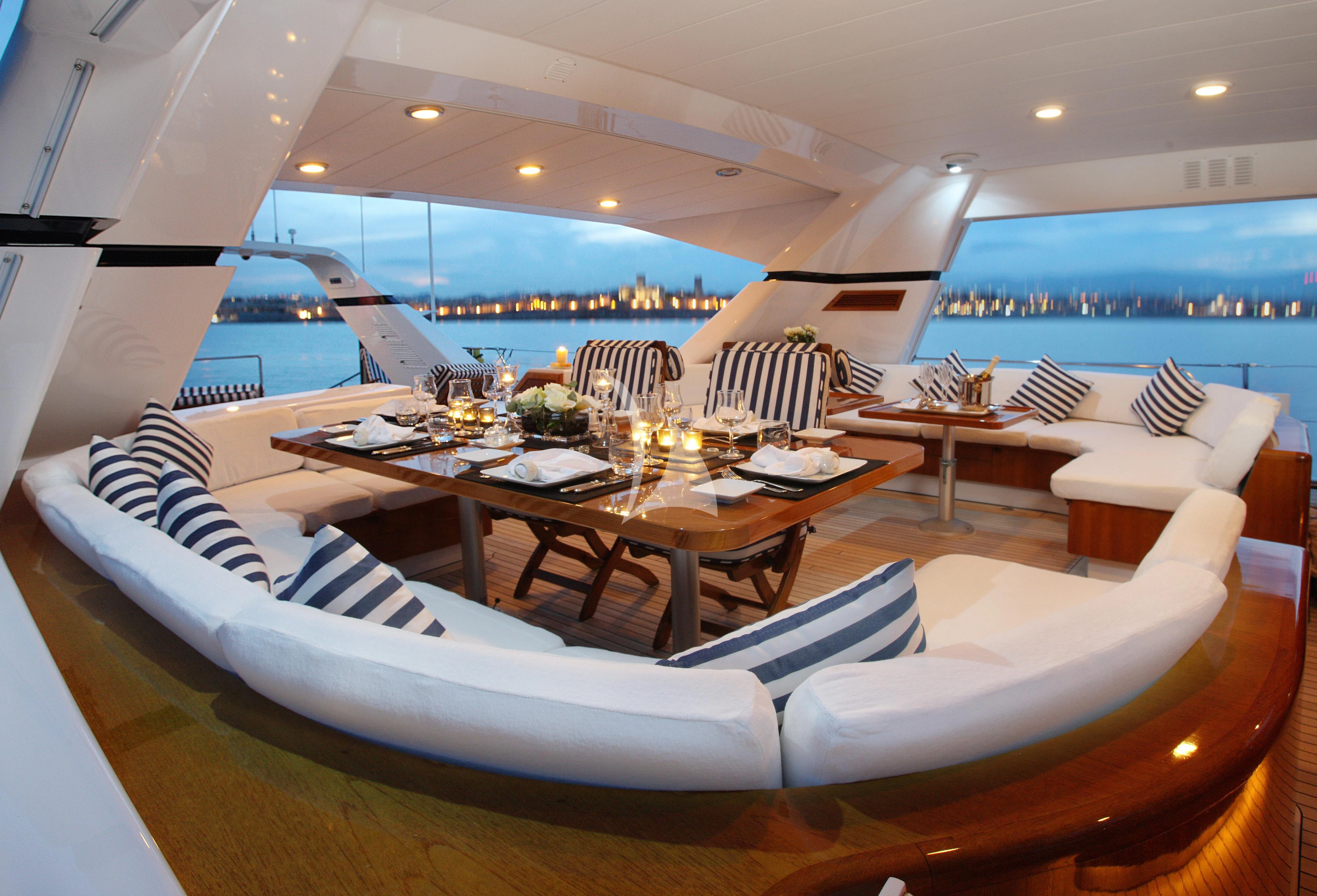 a room with tables and chairs aboard UNPLUGGED Yacht for Sale
