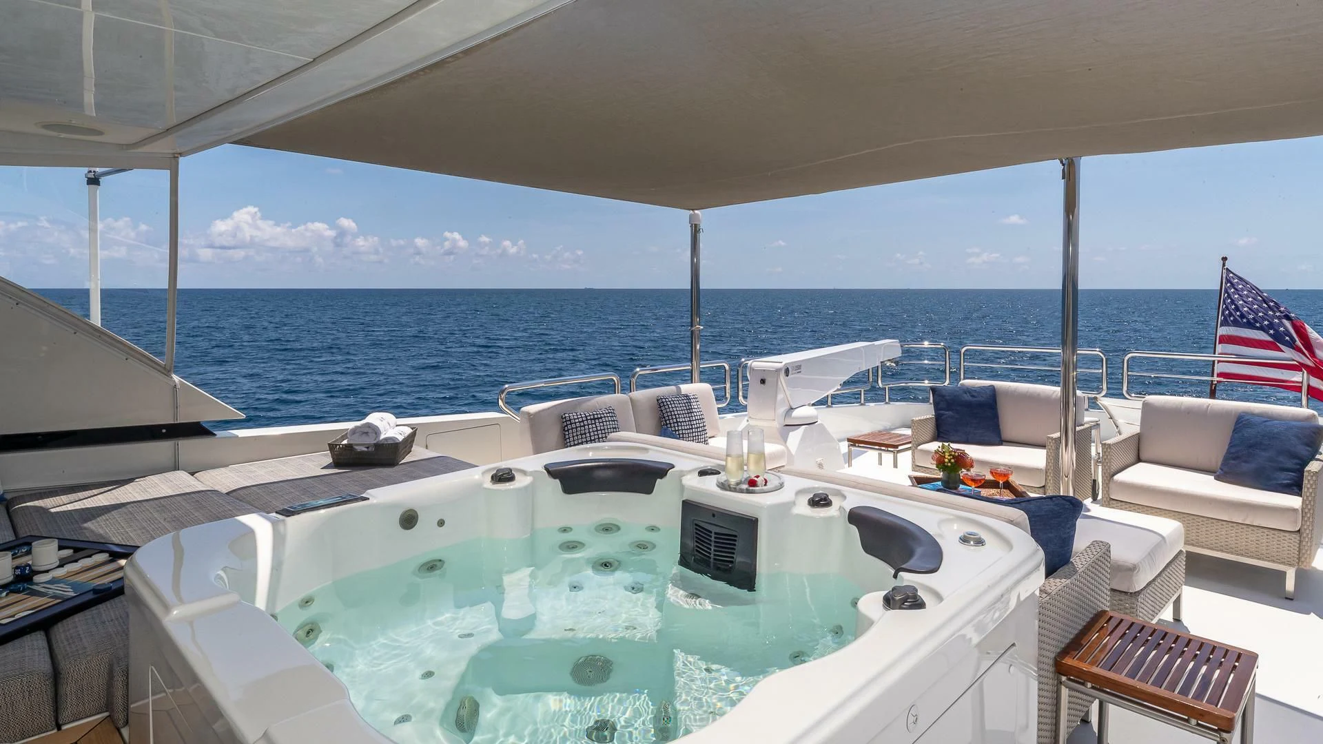 a large white boat with a blue and white striped pillow on it aboard BRAVO ZULU II Yacht for Sale