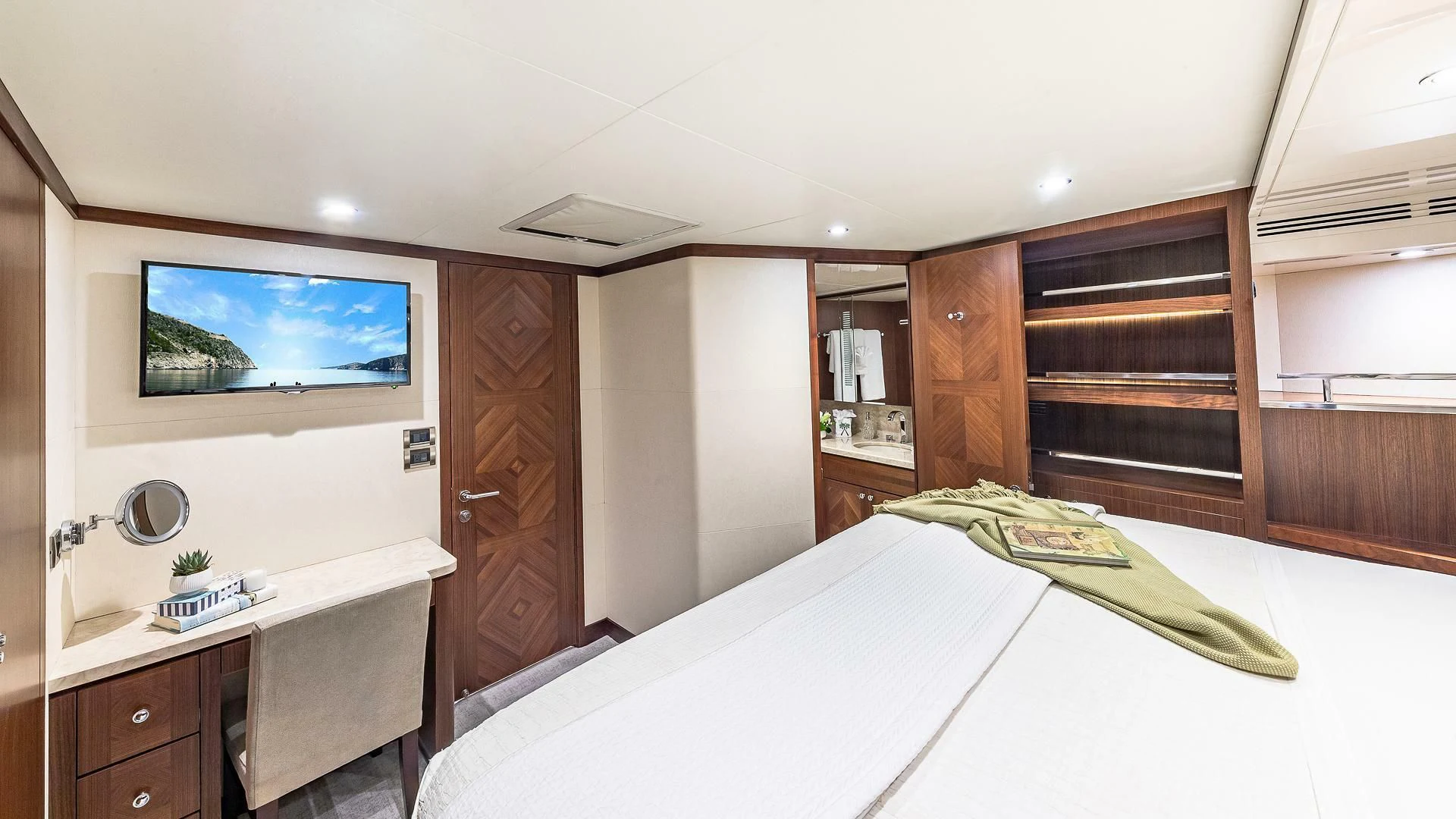 a bedroom with a bed and a desk aboard BRAVO ZULU II Yacht for Sale