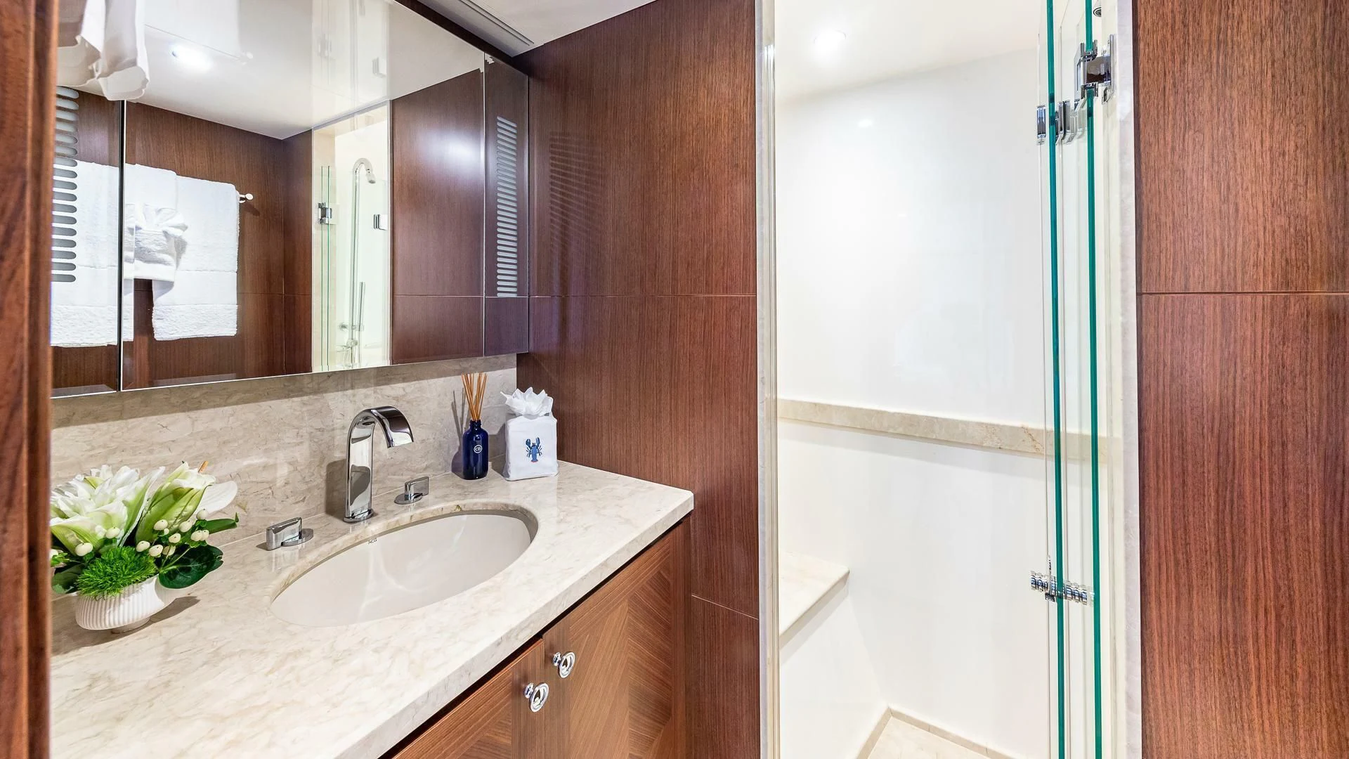 a bathroom with a sink and a mirror aboard BRAVO ZULU II Yacht for Sale